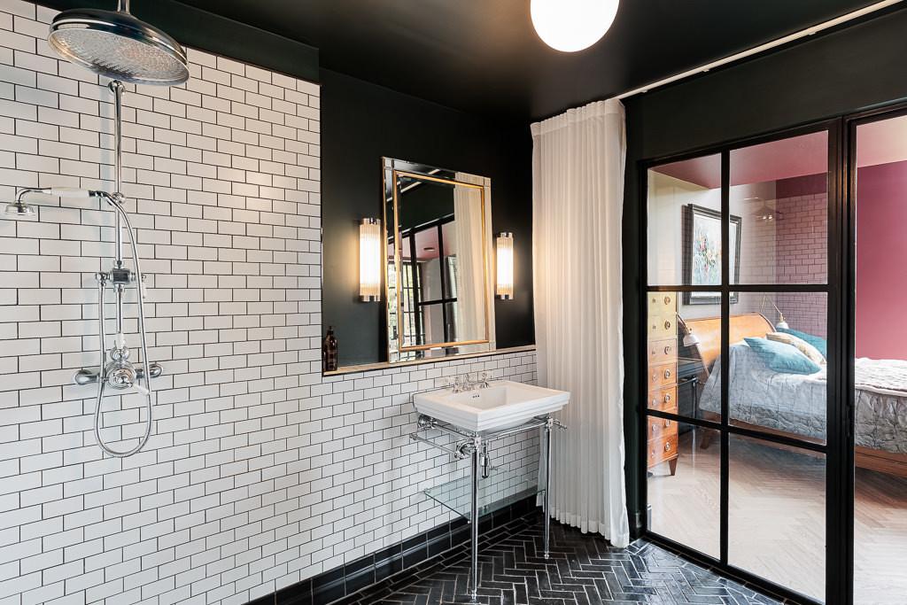 En suite wet room with metro tiles, rain shower and herringbone floor