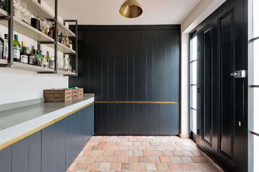 Dining room with black and white tiled floor and two glazed elevations