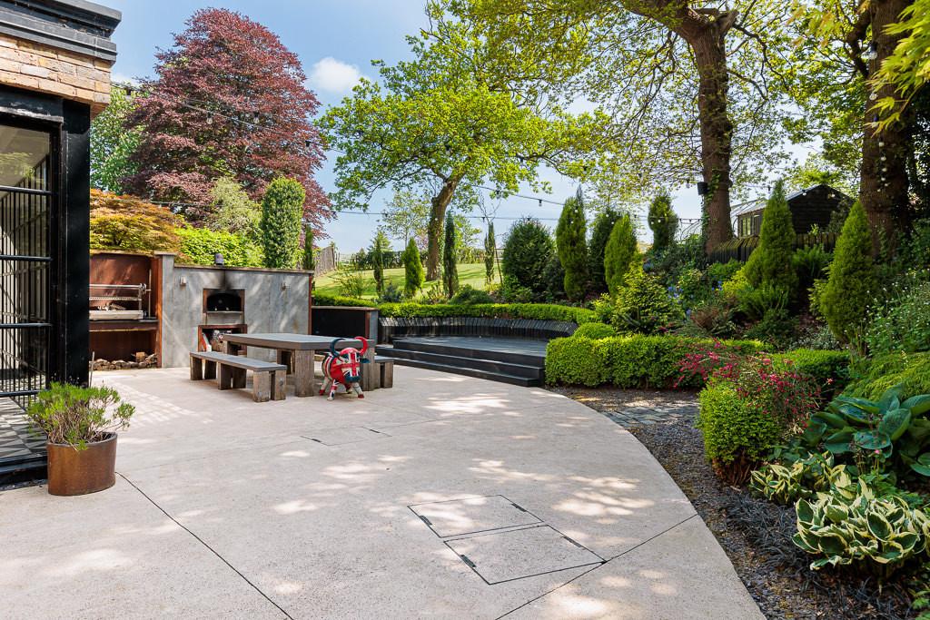 Rear terrace with built-in BBQ, pizza oven and landscaped gardens