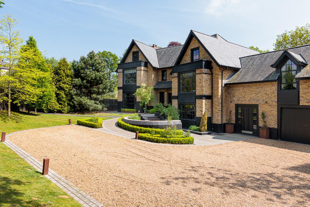 Front elevation with gravel driveway, formal parterre and double garage