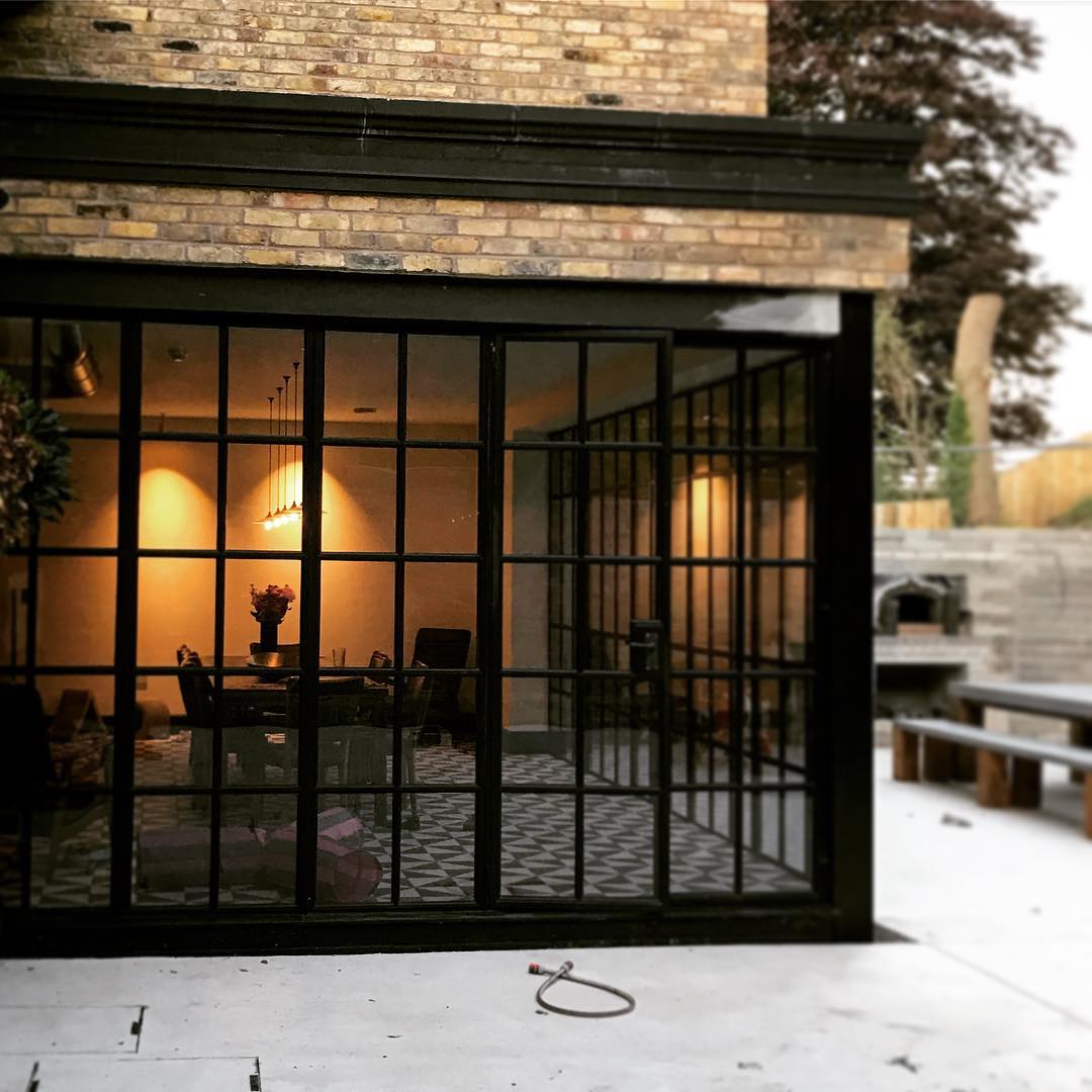 Rear elevation at dusk with Crittall glazing