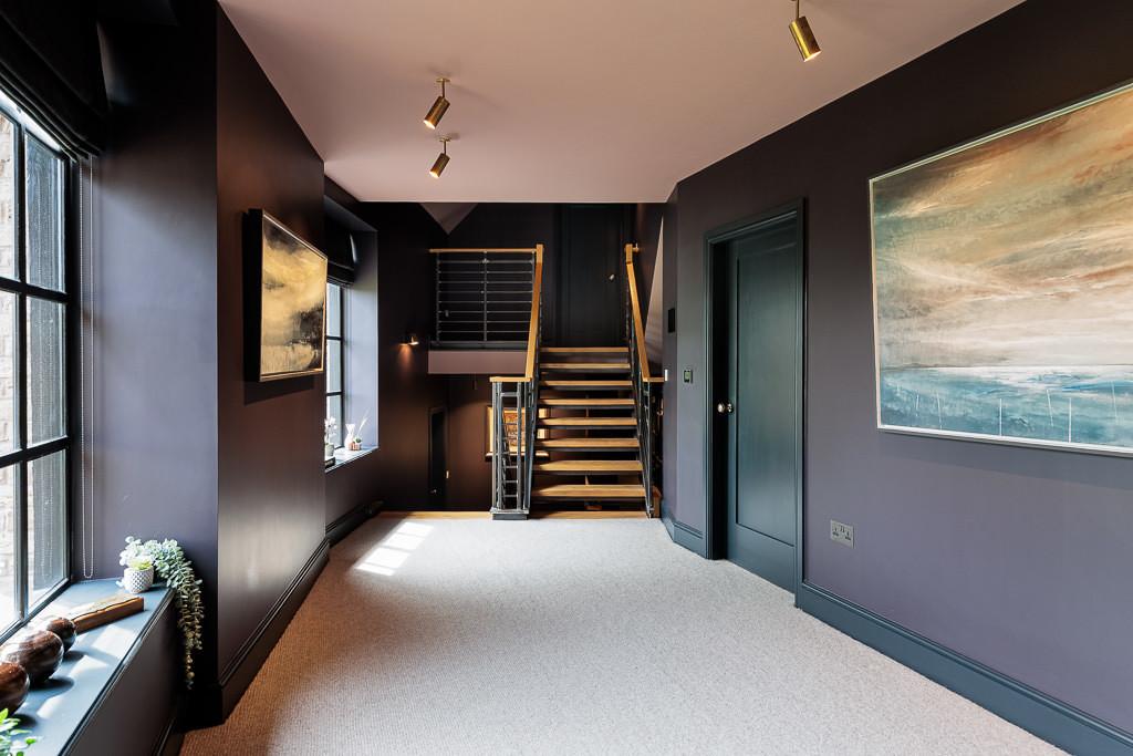 Dark moody landing with architectural lighting