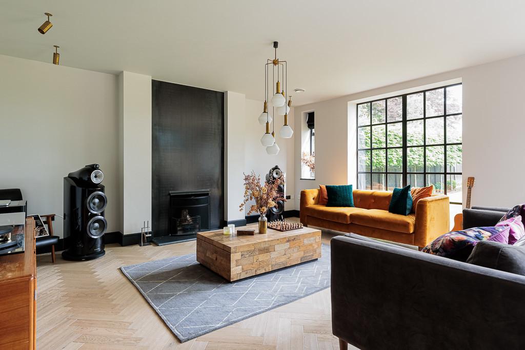 South-facing living room with feature fireplace and oak parquet flooring