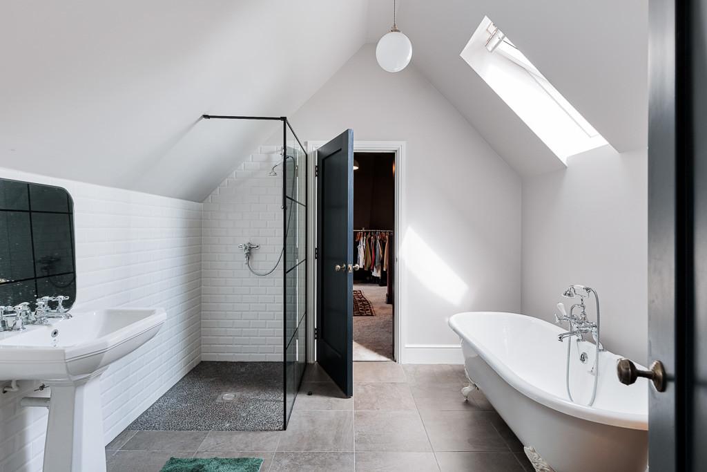 Freestanding bath with metro tiles and skylights