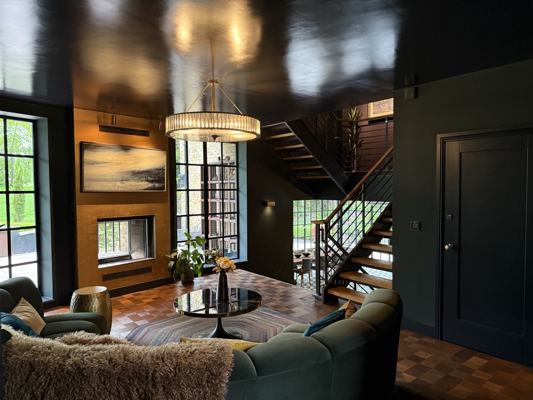 The Ponds Goostrey — main reception with gold-leaf fireplace, art deco chandelier and steel-frame staircase