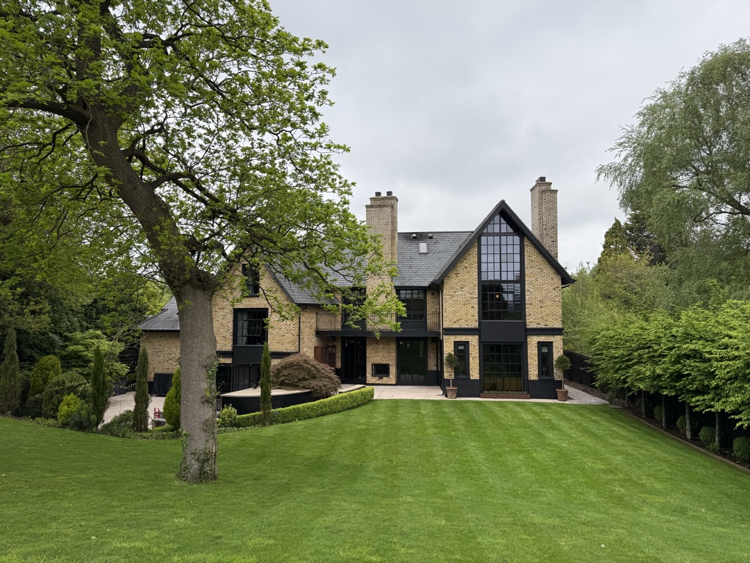 The Ponds Goostrey — rear elevation across the manicured lawn with mature oak in the foreground