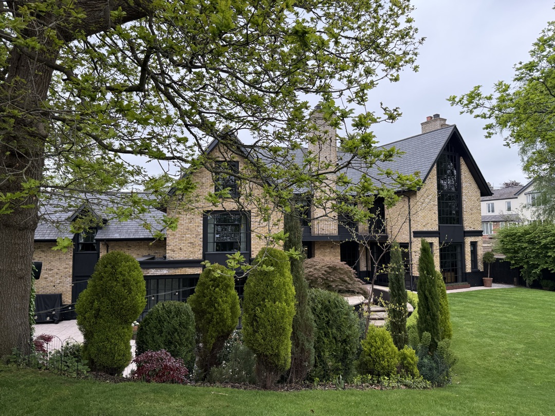 The Ponds Goostrey — rear elevation glimpsed through mature trees and hedging